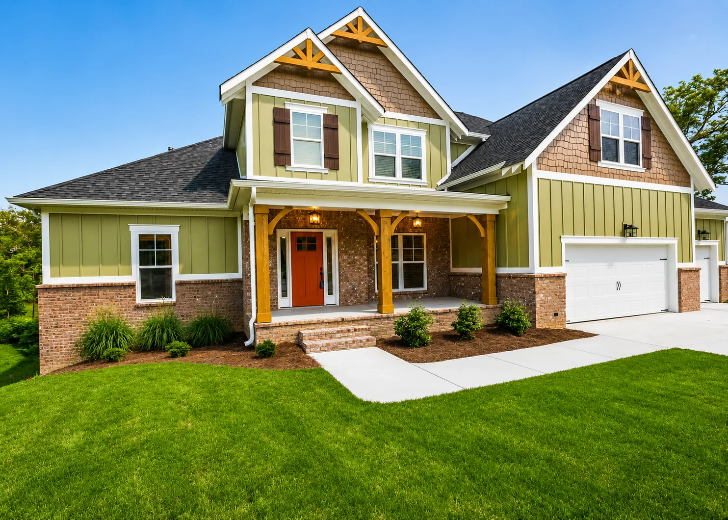 Modern suburban home with red door, green siding, and a three-car garage, built by Pratt Home Builders in Chattanooga TN.
