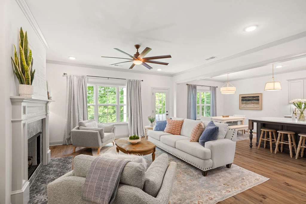 Modern living room with neutral tones, cozy seating, and open layout, designed by Pratt Home Builders in Chattanooga, TN.