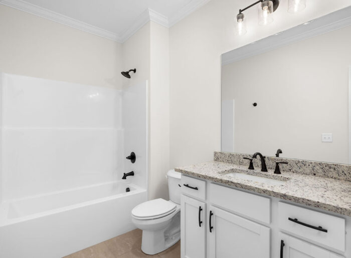 Guest bathroom with full shower and bath in new home now selling