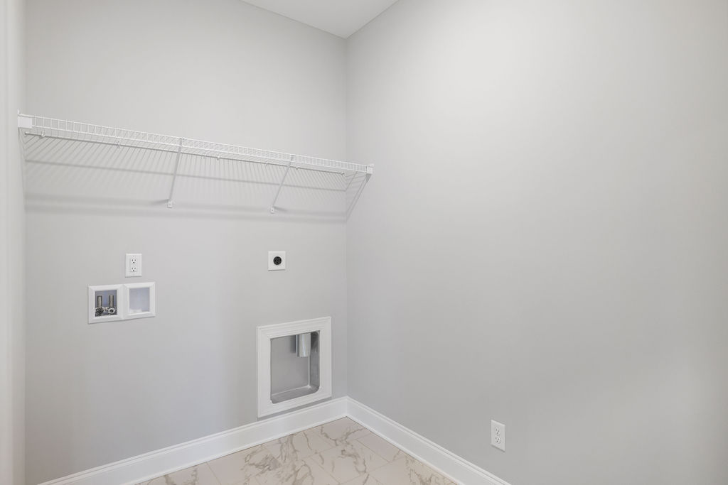 Spacious laundry room with built in shelving