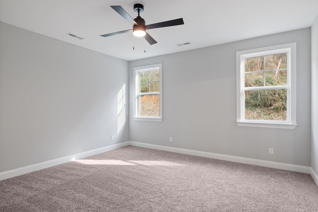 Primary bedroom with large windows providing natural light
