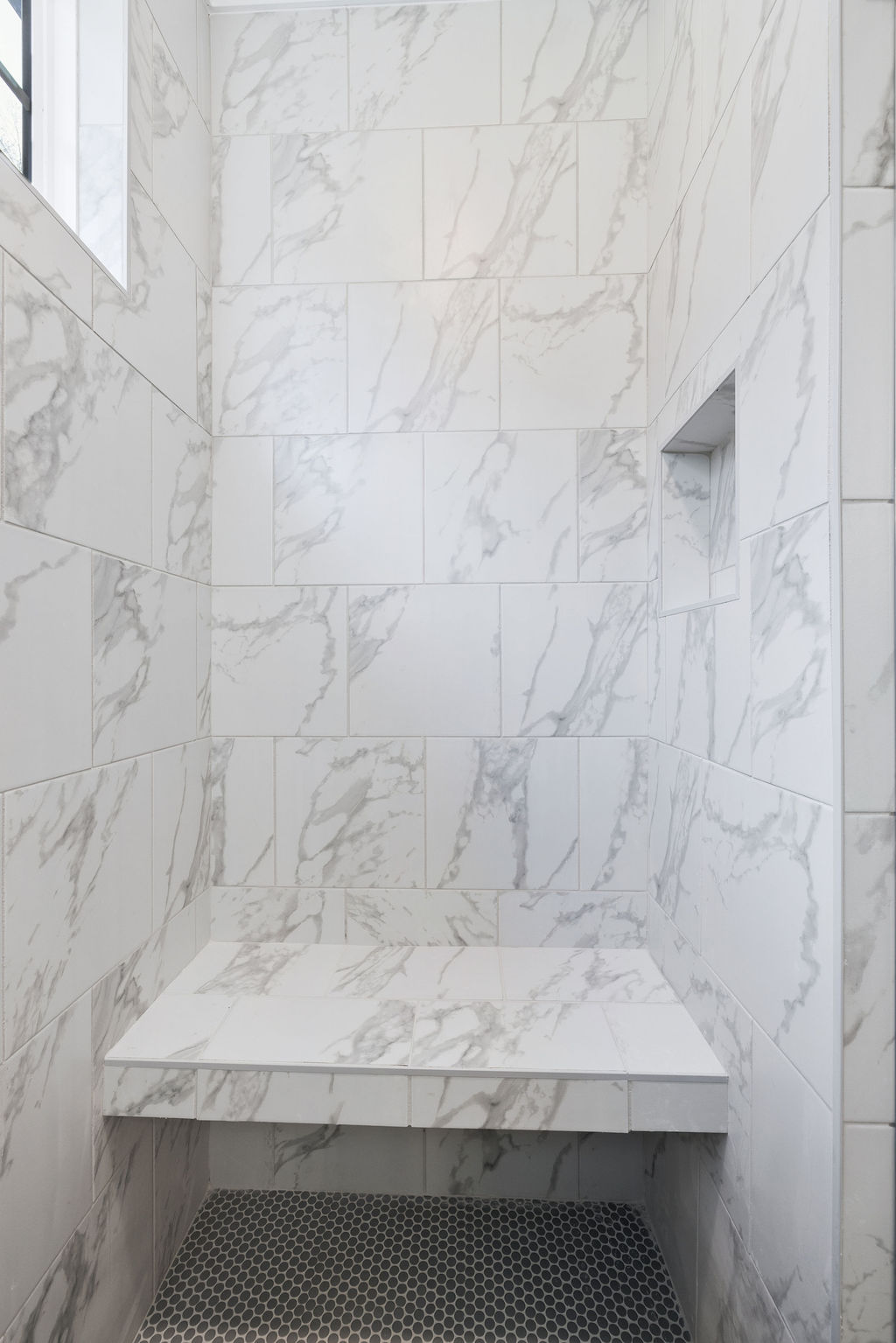 Large walk in shower with expert tilework and design in this new home selling