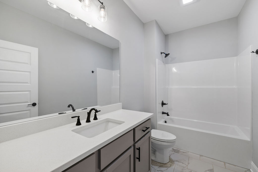 Full bathroom for guests or children in this new townhome by Pratt Home Builders