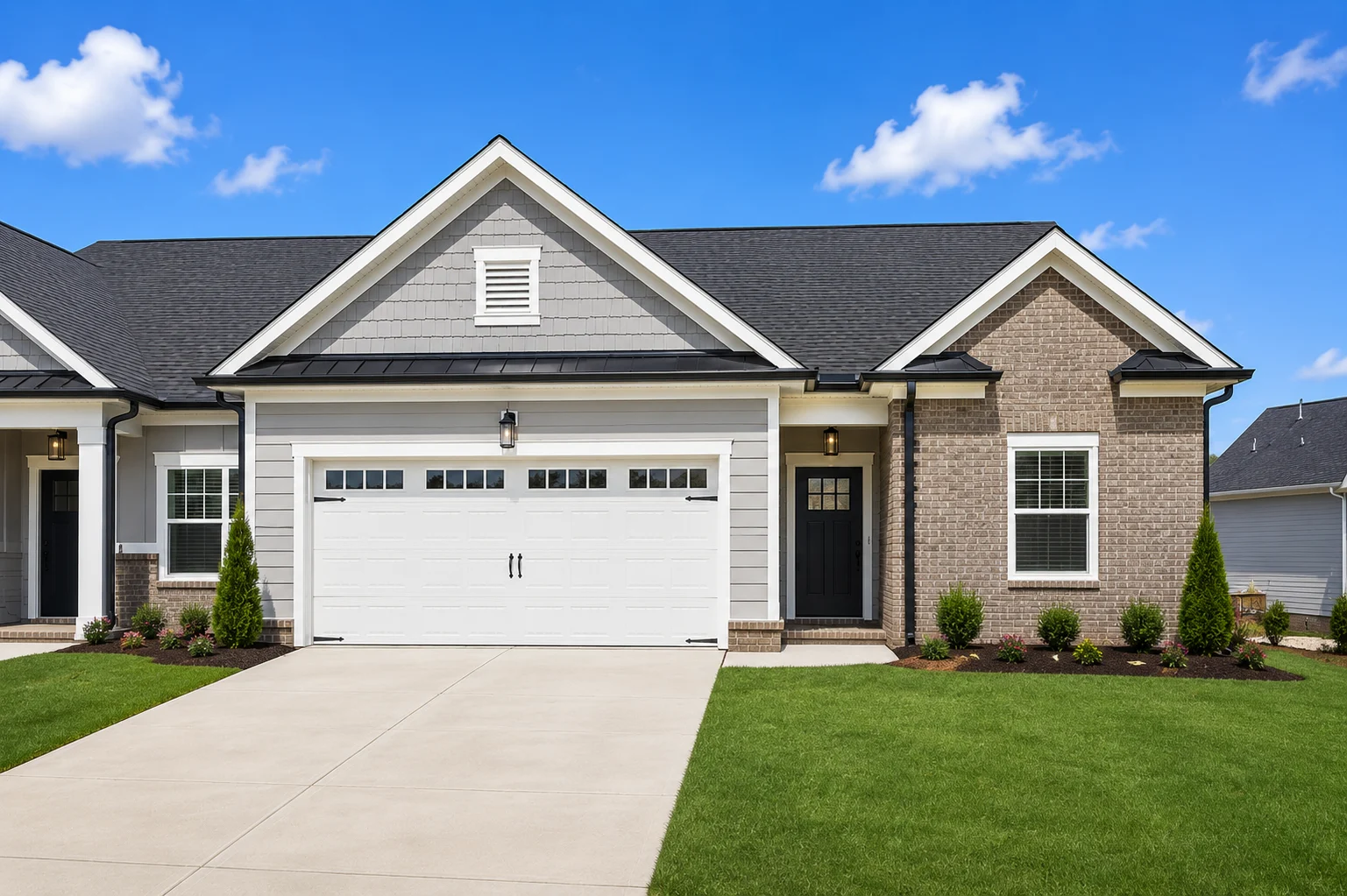 Lily-floor-plan-front-exterior-townhome-for-sale Modern single-story home with a two-car garage, built by Pratt Home Builders in Chattanooga TN, featuring brick and siding exterior.