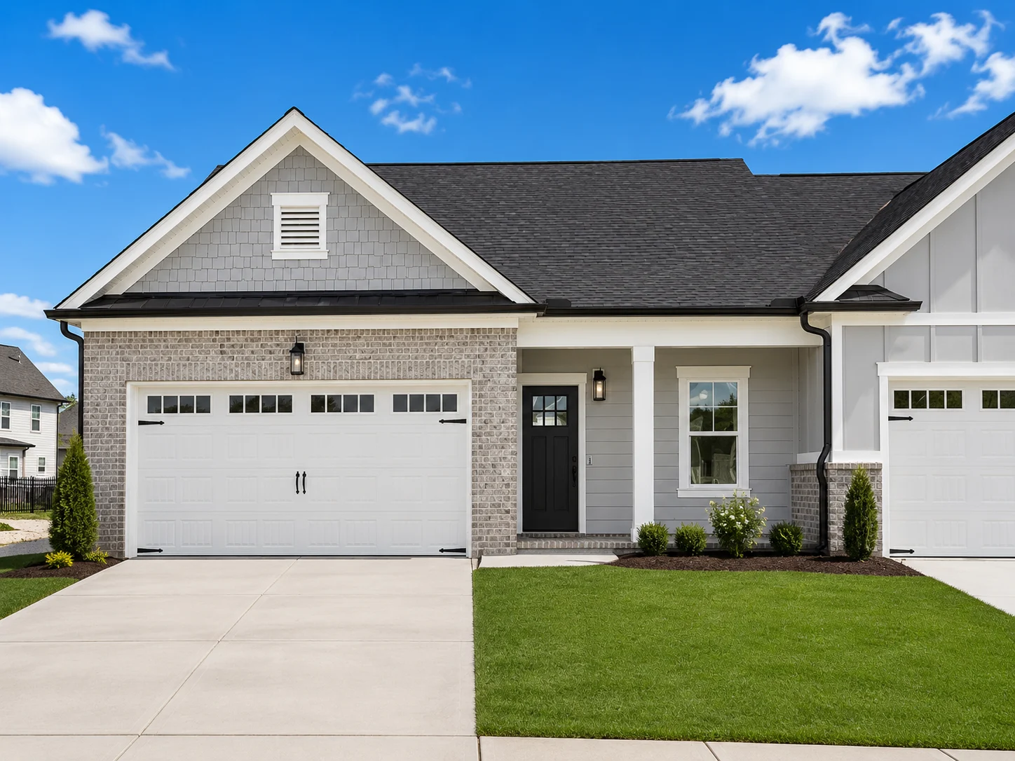 Orchid-floor-plan-front-exterior-townhome-for-sale Charming modern home by Pratt Home Builders in Chattanooga, TN, featuring a sleek garage, well-kept lawn, and gray brick exterior.