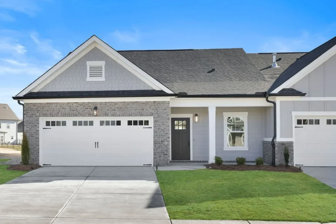 Single-story home with two-car garage, covered entrance, gray siding. Built by Pratt Home Builders in Chattanooga TN.