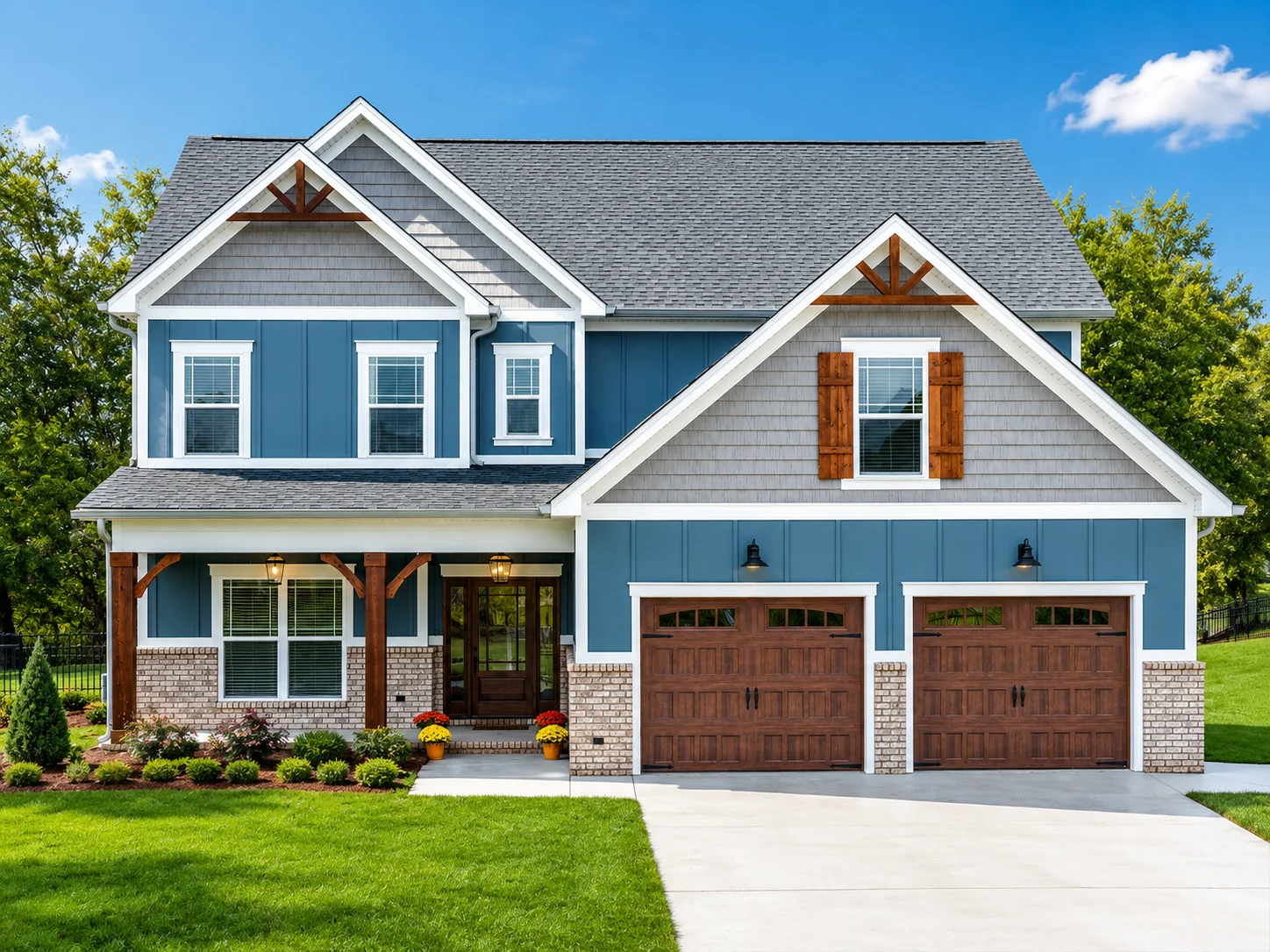 Two-story blue house with brick accents, wooden shutters, and a manicured lawn. Built by Pratt Home Builders in Chattanooga, TN.
