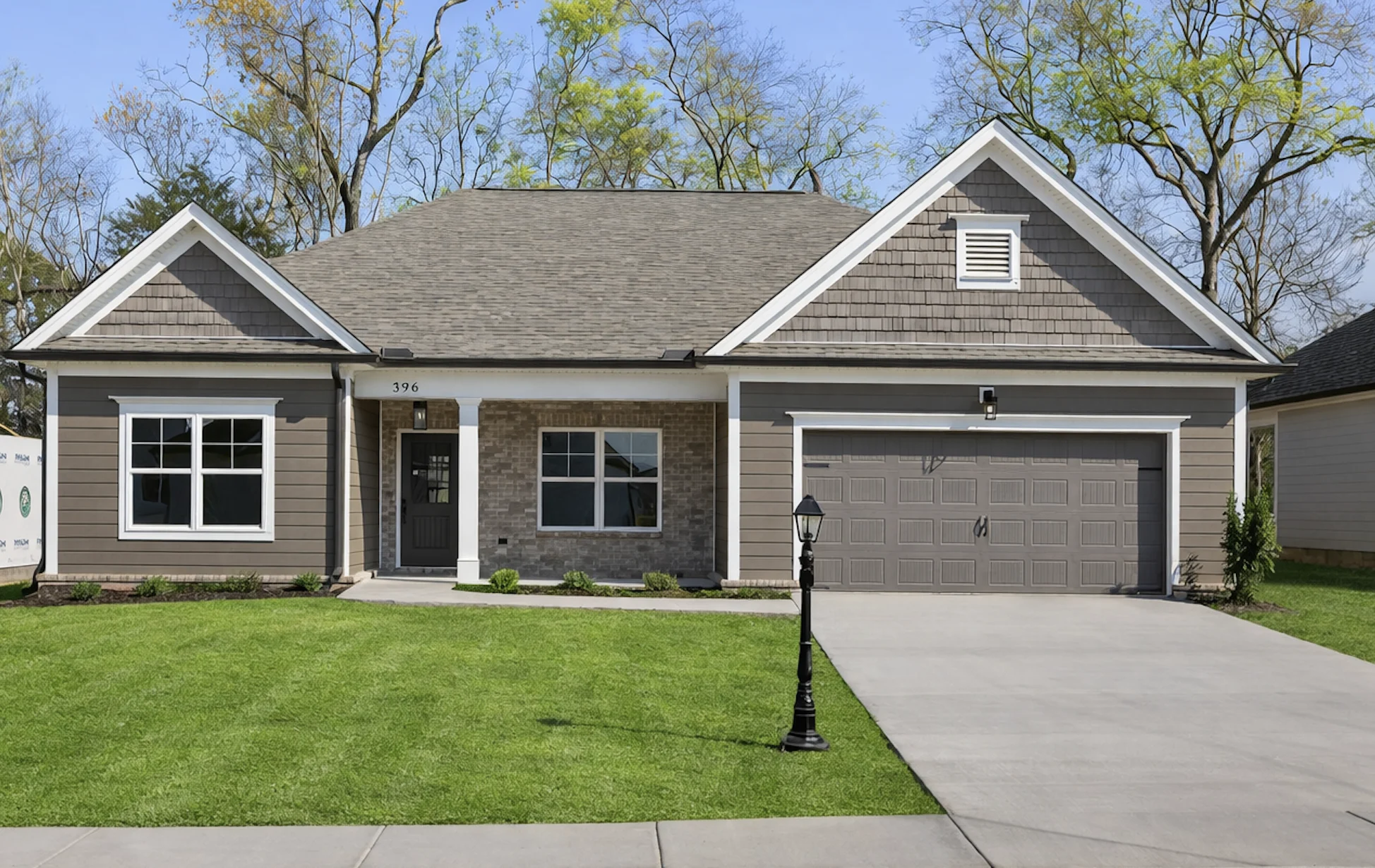 New Home Chattanooga TN. Modern single-story home with a gabled roof, gray siding, and well-kept lawn. Built by Pratt Home Builders in Chattanooga TN.