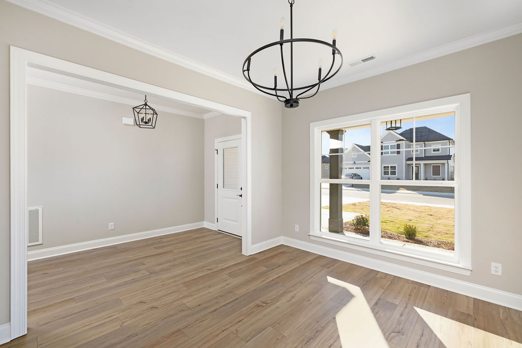 Dining room with designer lighting in new home now selling North Georgia