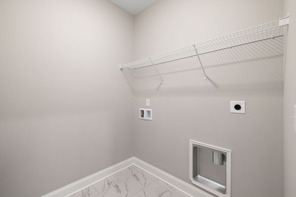 Laundry room with built-in shelving
