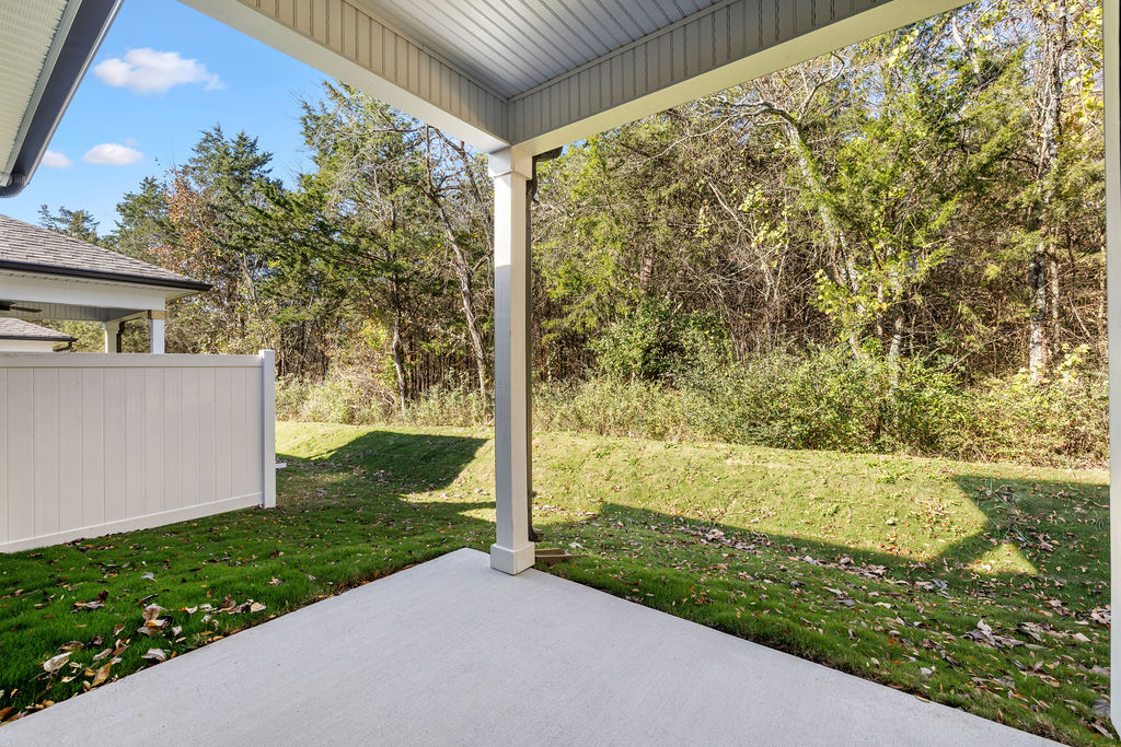 Covered outdoor patio for green space, pets and gathering in new construction Pratt townhome