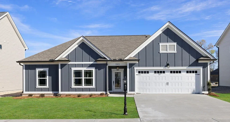 New Home Chattanooga TN. Modern gray house with white trim, manicured lawn, and a double garage. Built by Pratt Home Builders.