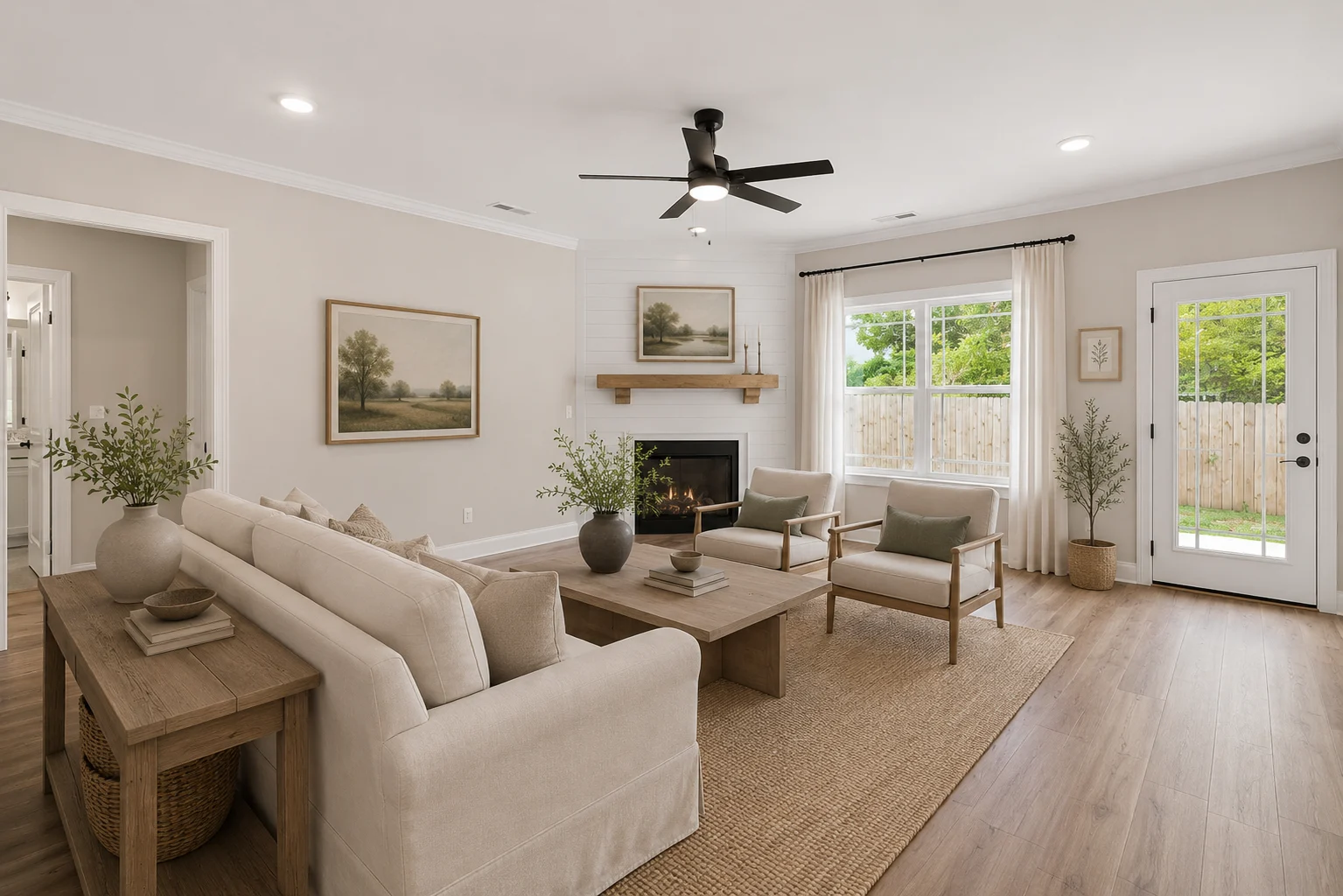 Modern living room by Pratt Home Builders in Chattanooga TN, featuring neutral tones, cozy furniture, large windows, and a minimalist fireplace.