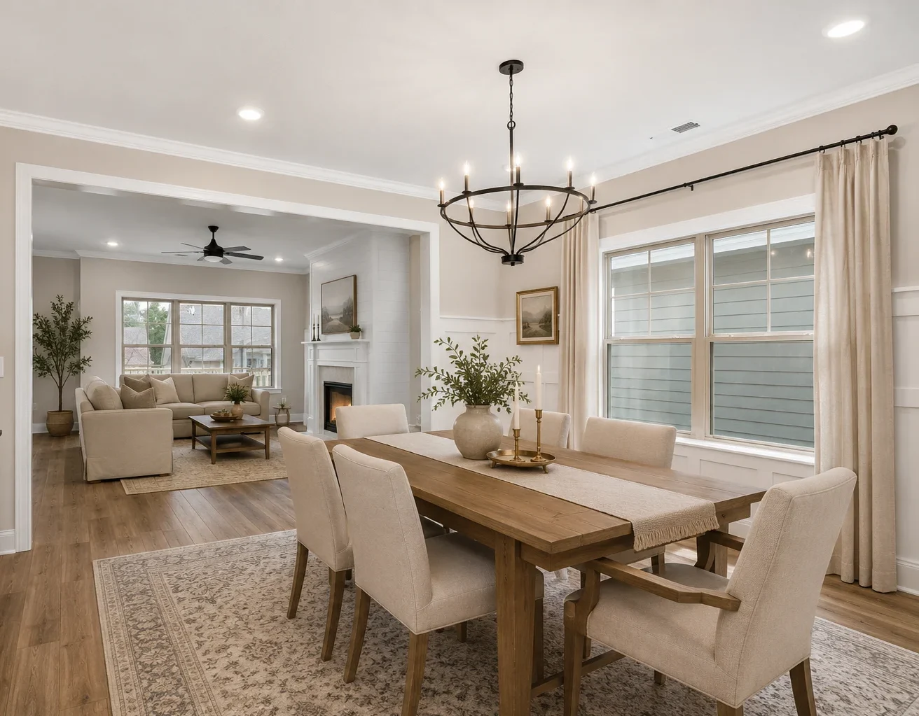 Elegant dining and living area with beige decor and wood furniture, designed by Pratt Home Builders in Chattanooga TN.