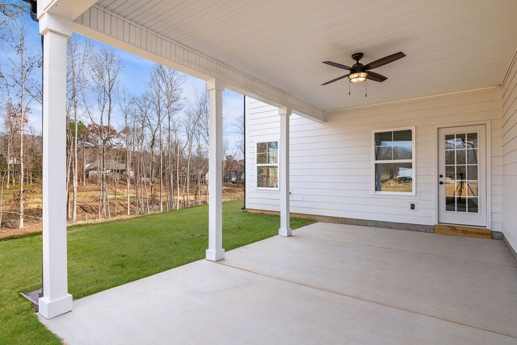 Covered patio for pets and gathering in this new Pratt home