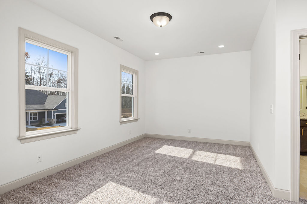 Guest of child's spacious bedroom with lots of natural lighting