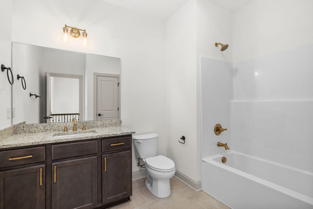 Full bath with designer finishes in new construction Pratt home selling now