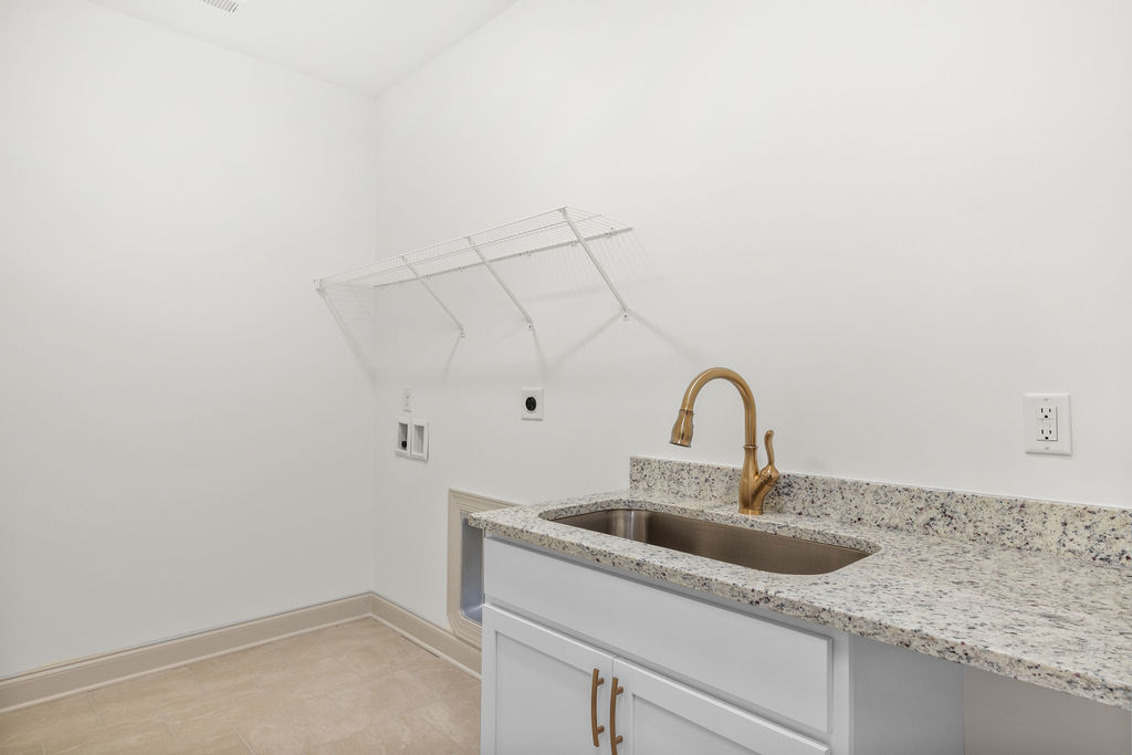 Spacious laundry room with shelving in new Pratt Home Builders home in greater Chattanooga