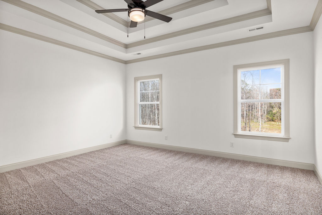 Primary Suite with oversized windows and designer finishes new Pratt home selling now