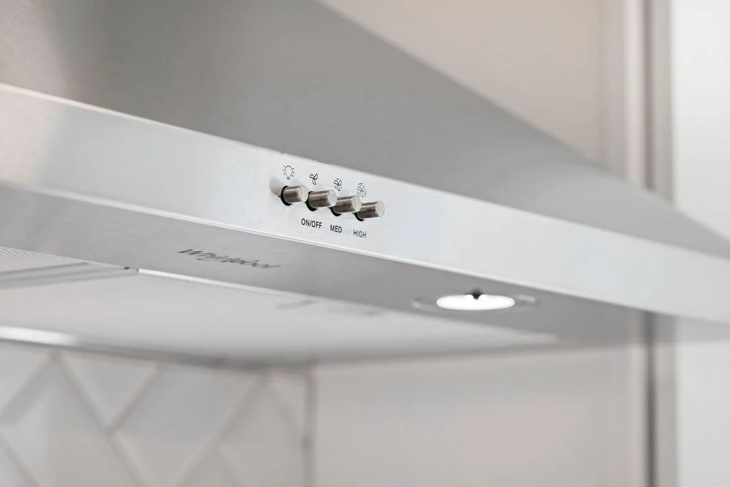 Stainless steel range hood with control buttons, part of a Pratt Home Builders project in Chattanooga, TN.