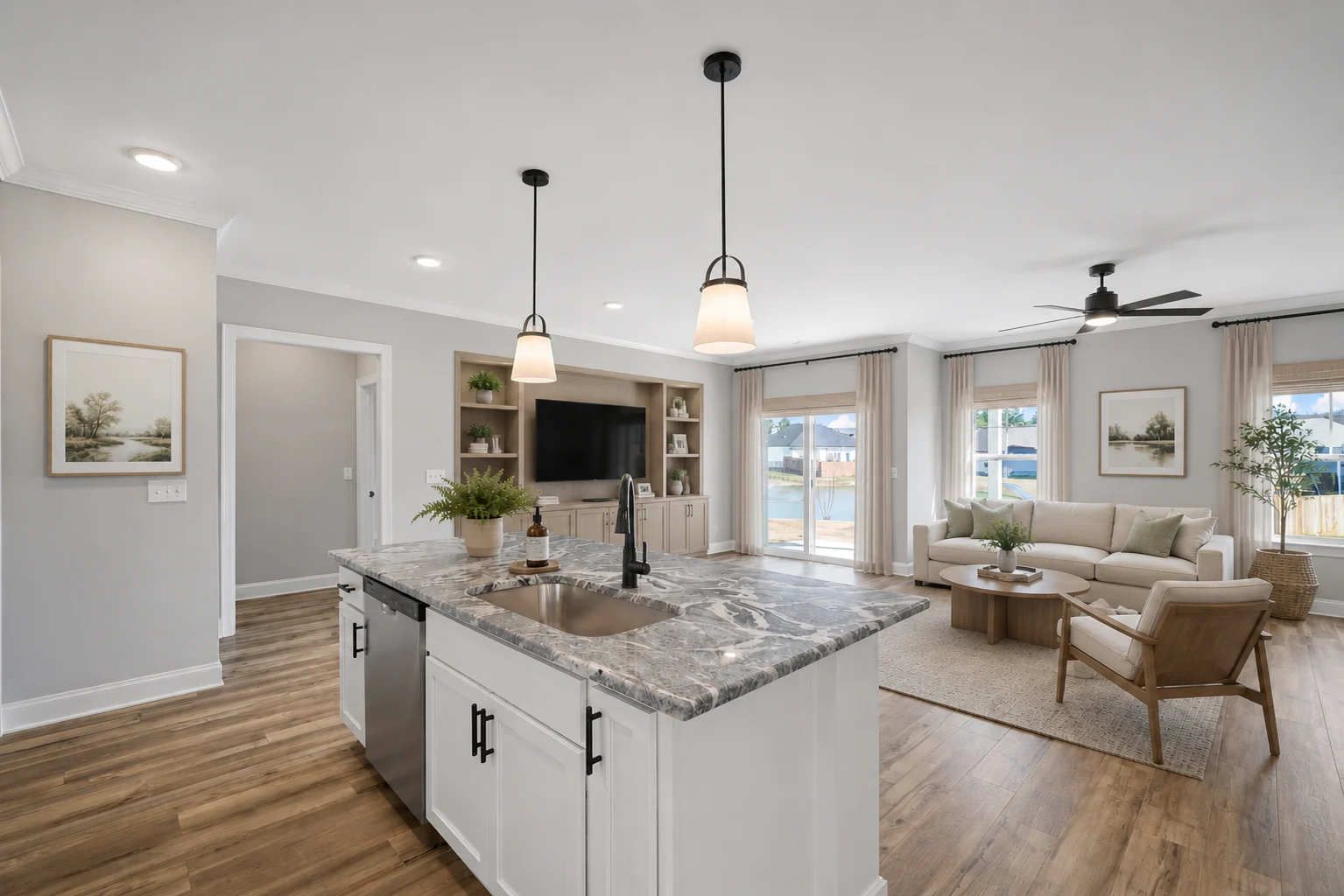 Modern open-concept living space with island kitchen and cozy lounge area, designed by Pratt Home Builders in Chattanooga TN.