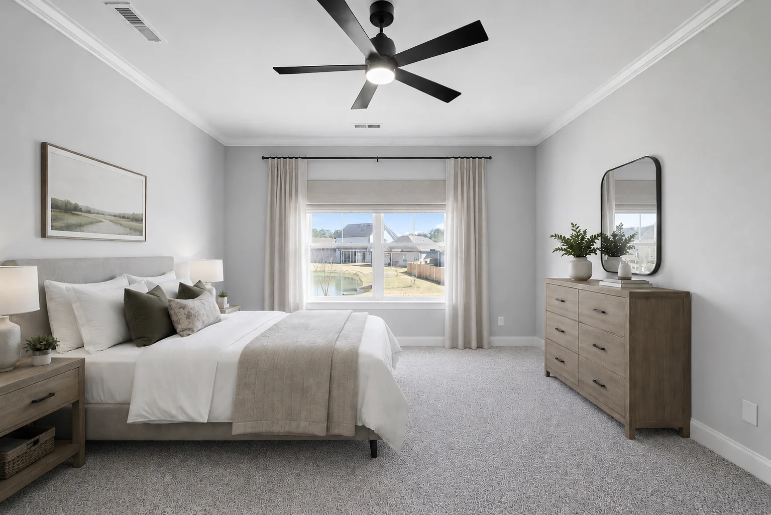 Spacious bedroom with neutral decor, bed, dresser, and ceiling fan. Large window overlooking backyard. Built by Pratt Home Builders in Chattanooga TN.