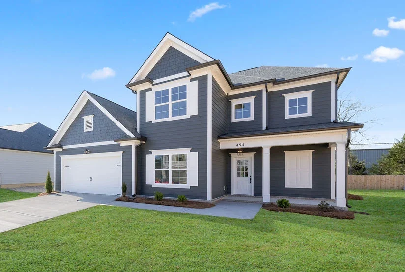Peyton-floor-plan-front-exterior New Home Chattanooga TN. Two-story dark gray house with white trim by Pratt Home Builders featuring a front porch and integrated garage.