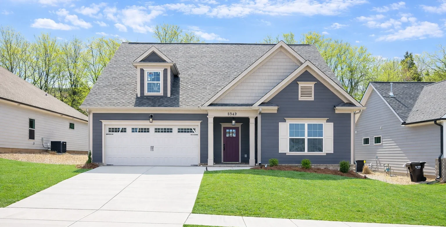 Laurel-floor-plan-front-exterior New Home Chattanooga TN. Gray single-story house with white garage, green lawn, built by Pratt Home Builders.