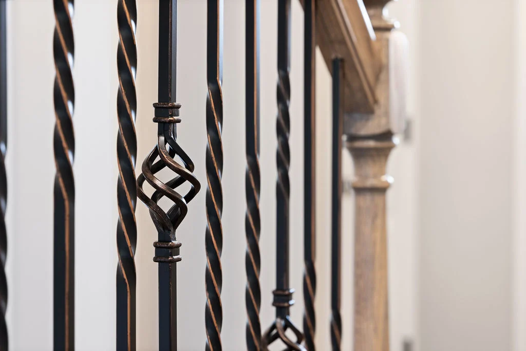 New Home Chattanooga TN. Elegant iron staircase railing with twisted balusters and intricate design by Pratt Home Builders.