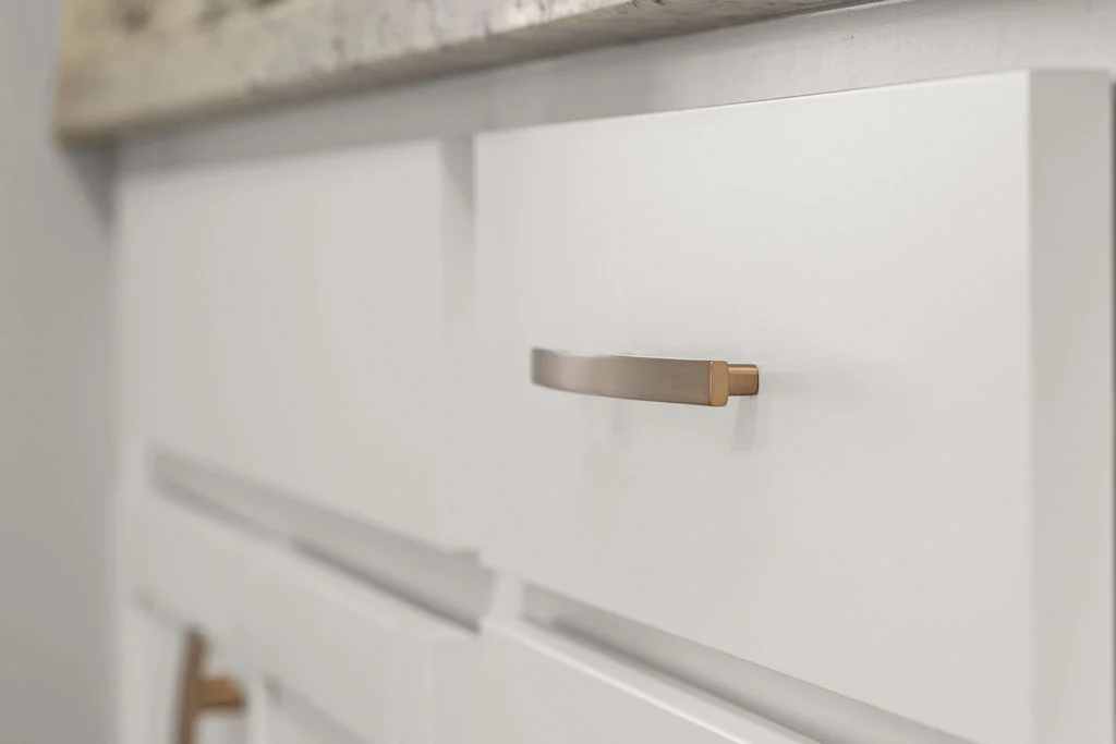 Close-up of modern white cabinet with streamlined metallic handle by Pratt Home Builders in Chattanooga TN.
