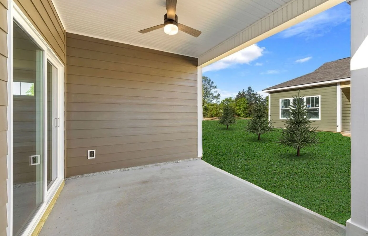 New Home Chattanooga TN. Covered patio with ceiling fan overlooking green lawn and young trees, built by Pratt Home Builders.