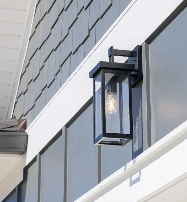 Modern outdoor lantern against gray siding, part of Pratt Home Builders in Chattanooga TN, showcasing contemporary architectural design.