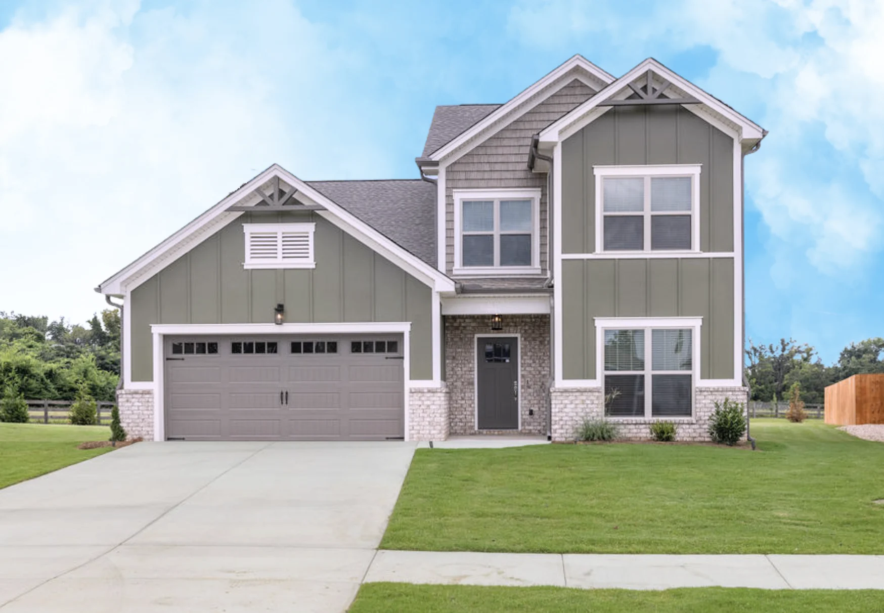 New Home Chattanooga TN. Modern two-story green and gray house by Pratt Home Builders, featuring a spacious lawn and 2-car garage.