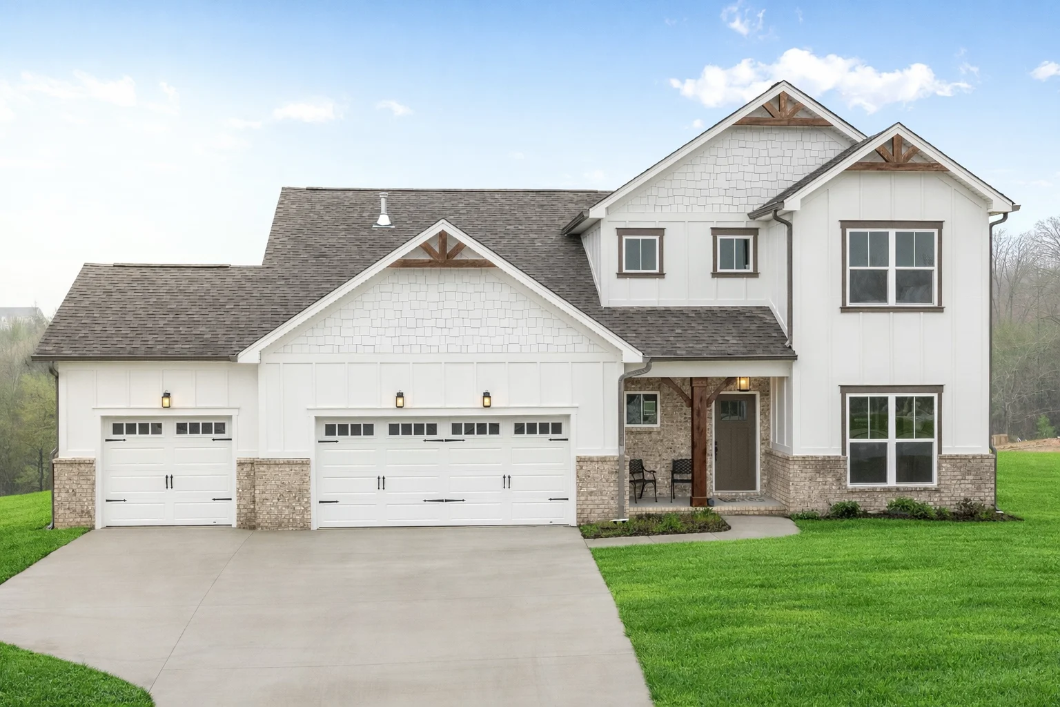 New Home Chattanooga TN. Modern white two-story home with a three-car garage and brick accents by Pratt Home Builders.