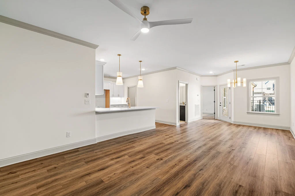 Spacious open-concept living area with wood flooring, modern fixtures, and natural light by Pratt Home Builders in Chattanooga TN.