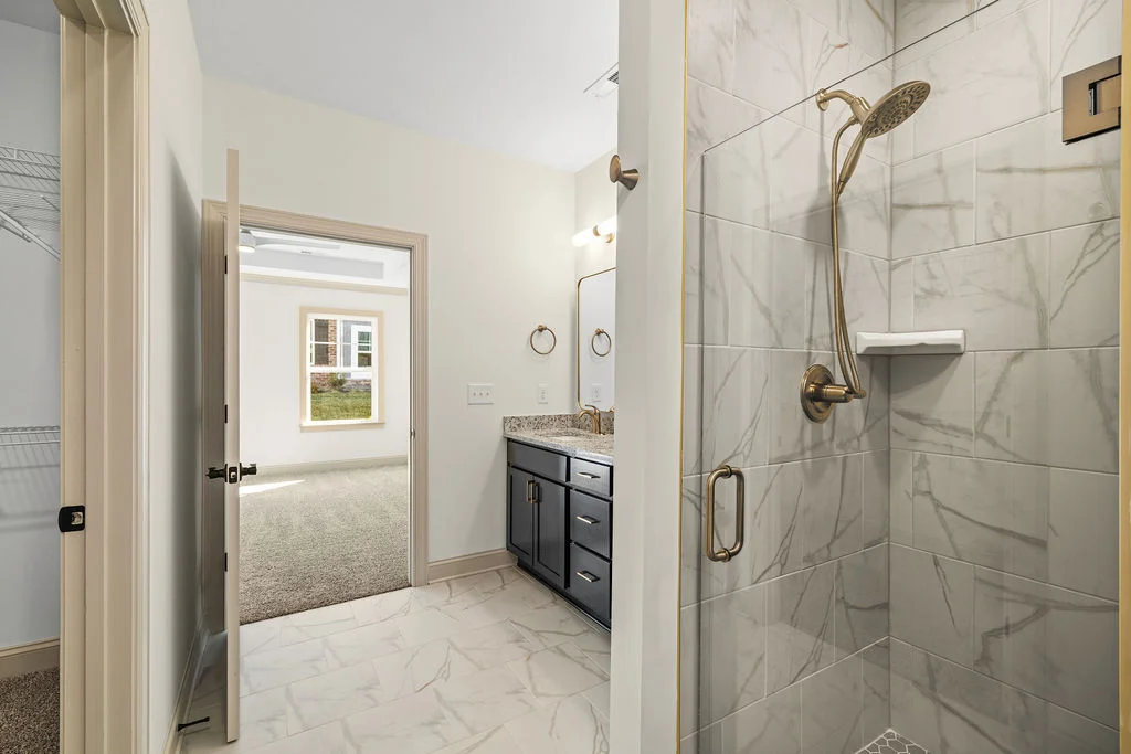 New Home Chattanooga TN. Granite countertops, walk in shower tiled with bench, neutral design bathroom.