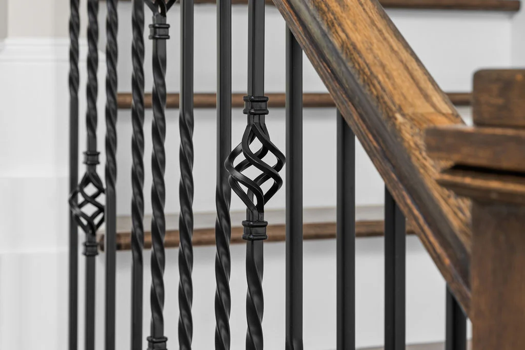Elegant iron balusters with twisted designs on a wooden staircase, crafted by Pratt Home Builders in Chattanooga TN.