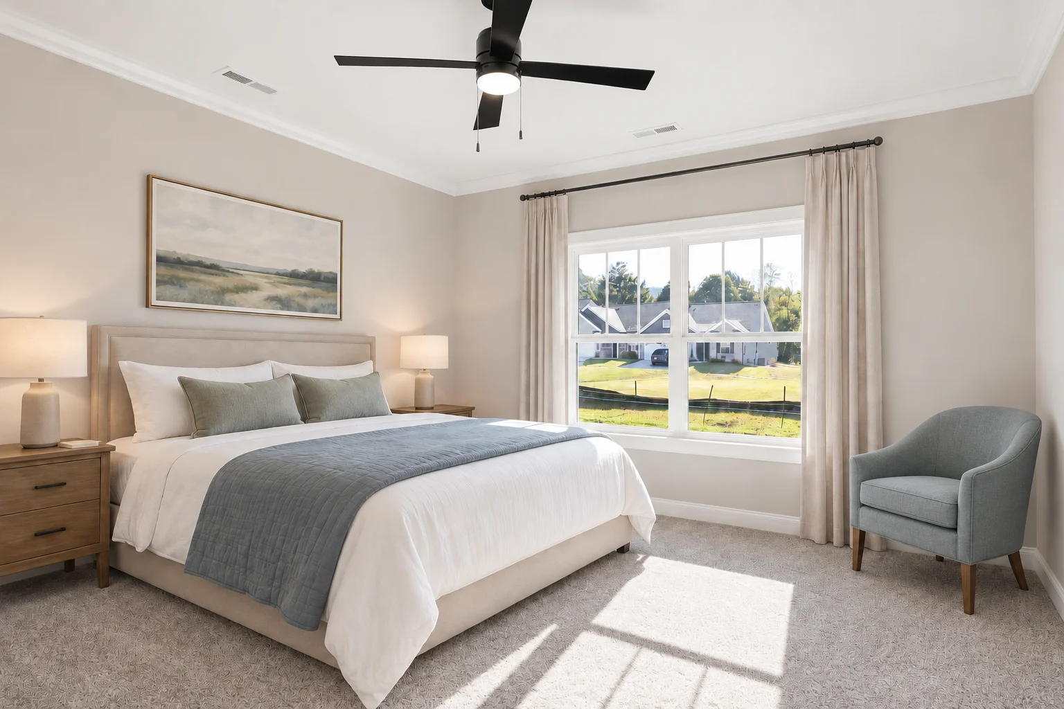 Bright, modern bedroom by Pratt Home Builders in Chattanooga TN. Features a bed, large window, armchair, and landscape artwork.