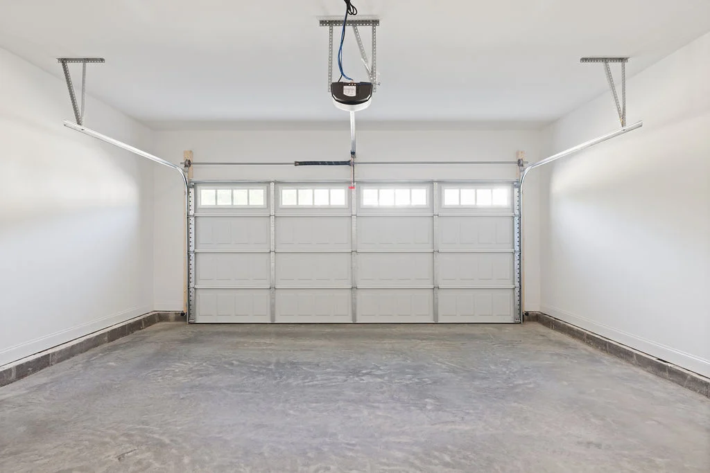 Spacious, clean garage with a closed door, built by Pratt Home Builders in Chattanooga TN.