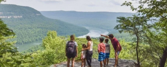 Family enjoying scenic view of mountains and river, highlighting outdoor lifestyle near Pratt Home Builders in Chattanooga TN.