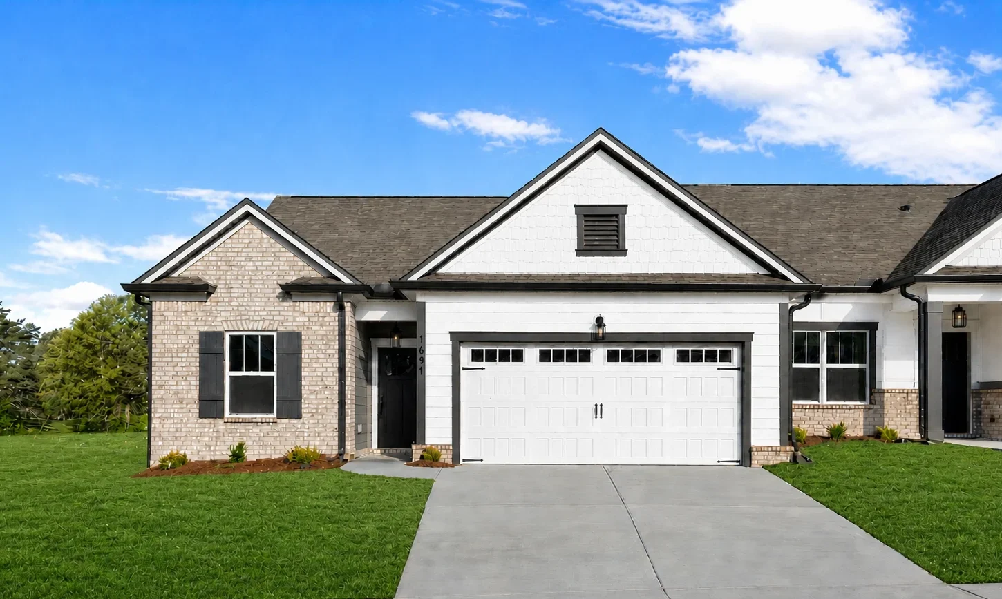 Single-story home with brick and white siding, landscaped yard, and double garage by Pratt Home Builders in Chattanooga TN.