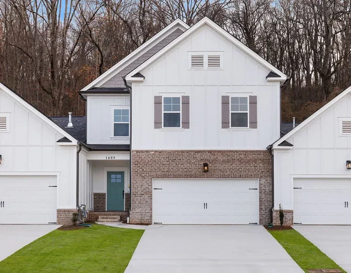 Blueridge-floorplan-outdoor-exterior-home-for-sale Modern white duplex with three garages, brick accents, and manicured lawns by Pratt Home Builders in Chattanooga TN.