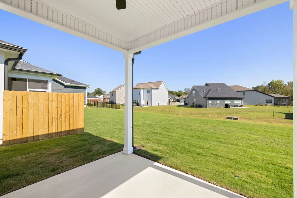 Covered patio overlooking a spacious lawn and neighboring homes, showcasing Pratt Home Builders in Chattanooga TN craftsmanship.