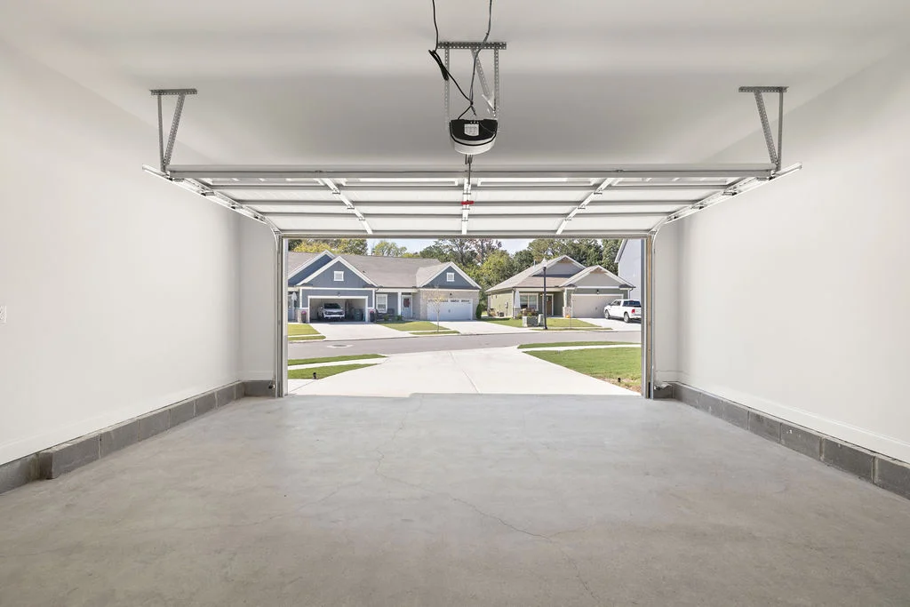 View from an empty garage looking out at a suburban street with houses, built by Pratt Home Builders in Chattanooga TN.