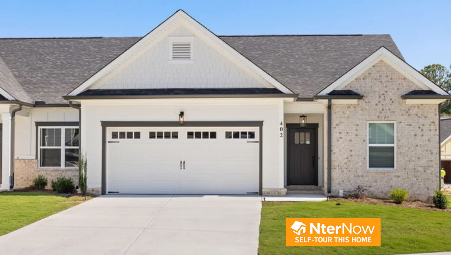 Modern single-story home by Pratt Home Builders in Chattanooga, TN, featuring brick exterior and two-car garage, with self-tour option available.