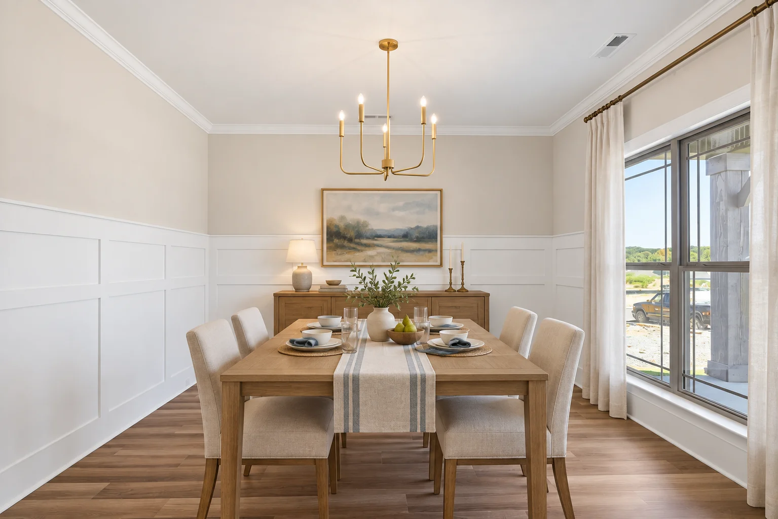 Elegant dining room by Pratt Home Builders in Chattanooga TN, featuring wooden furniture, a modern chandelier, and large windows with natural light.