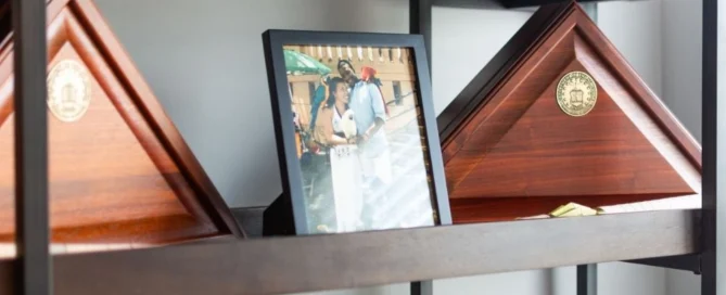 Wooden shelves displaying military flag cases and a framed photo, associated with Pratt Home Builders in Chattanooga TN.