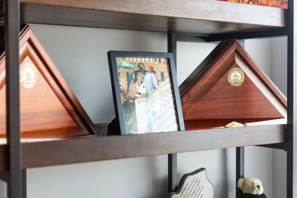 Wooden shelves displaying military flag cases and a framed photo, associated with Pratt Home Builders in Chattanooga TN.