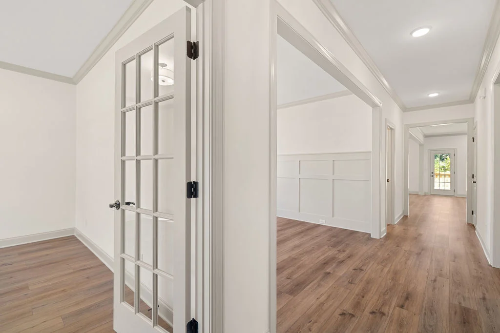 Bright hallway with French doors and wood flooring, showcasing modern design by Pratt Home Builders in Chattanooga TN.