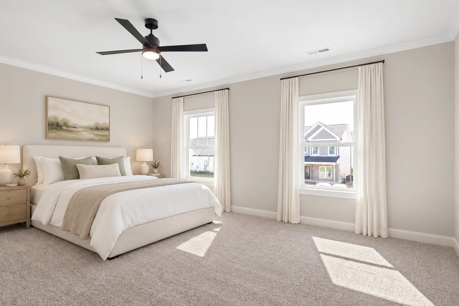 Spacious bedroom with neutral decor, large bed, ceiling fan, and sunlight through windows. Elegant design by Pratt Home Builders in Chattanooga TN.